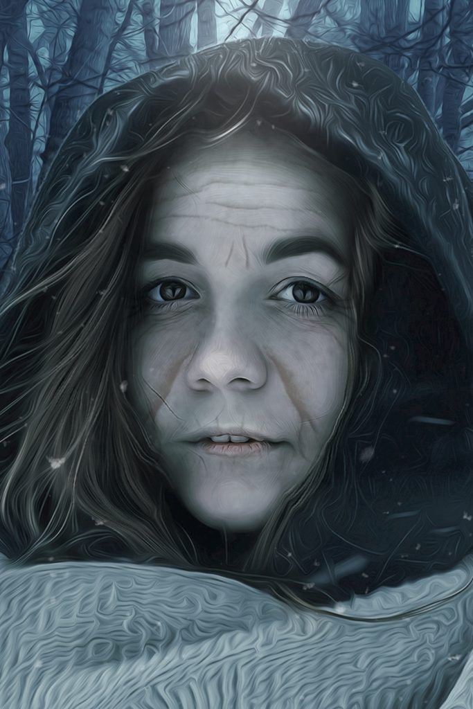 the face of a dark-hooded older woman with light skin and dark hair, She wears a grey scarf. The background is a woods in winter, and she has a scarf loosely around her shoulders and neck.