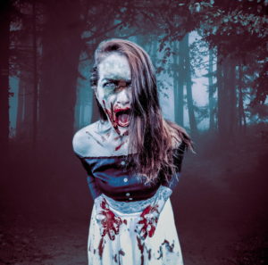 A undead screaming girl. She's wearing a dress and has long hair draped over her left shoulder. Her hands are together near her waist, and her mouth and hands drip blood.