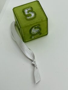 green D6 with silver glitter numbers and silver ribbon