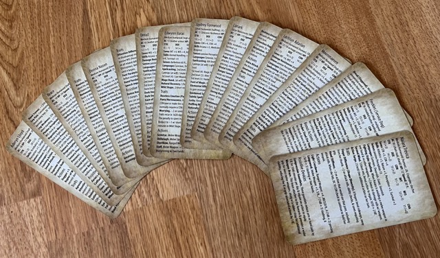 A spread of character cards, stat block side