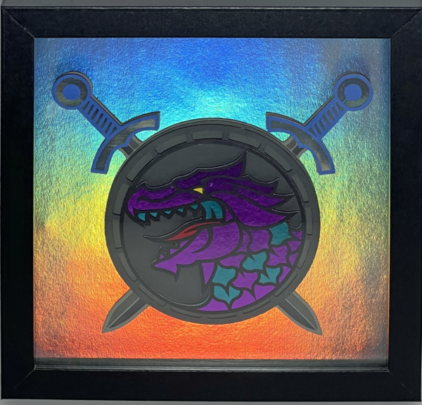 a picture of a purple & blue dragon head on a round shield with swords in a frame
