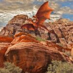 a red dragon flying over a rocky mountain